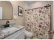 Well-lit bathroom with granite countertop, decorative shower curtain, and modern fixtures at 3121 Suffolk Dr, Shelby, NC 28152
