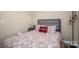 The cozy bedroom has a bed with a flower-patterned comforter and a snuggle pillow, with wooden floors at 3121 Suffolk Dr, Shelby, NC 28152