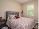 Bedroom featuring a plush bed with stylish linens, a modern lamp, and ample natural light at 3121 Suffolk Dr, Shelby, NC 28152