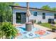 Relaxing outdoor patio with a blue patterned rug, table and chair, and a sliding glass door at 3121 Suffolk Dr, Shelby, NC 28152