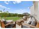 Cozy backyard with stylish patio furniture, lush green grass, and attractive landscaping at 3619 Slider Ter, Lancaster, SC 29720