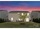 Backyard at twilight featuring patio seating and manicured lawn at 3619 Slider Ter, Lancaster, SC 29720