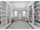 Elegant living room featuring custom bookshelves, a decorative chandelier, and serene natural light at 3619 Slider Ter, Lancaster, SC 29720