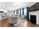 Bright living room with a fireplace, large windows, and modern furnishings flows into the spacious kitchen at 3619 Slider Ter, Lancaster, SC 29720
