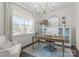 Bright home office features a modern chandelier, large window, and built in cabinetry with a decorative rug at 3619 Slider Ter, Lancaster, SC 29720