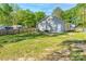 Large backyard featuring lush lawn and a privacy fence, offering ample space for recreation and relaxation at 402 Digh St, Gastonia, NC 28052
