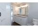 Bathroom with double vanity featuring granite countertops, bright lighting and tile flooring at 402 Digh St, Gastonia, NC 28052