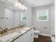 Bathroom boasts double sinks with granite counters, white cabinets, and a large mirror at 402 Digh St, Gastonia, NC 28052