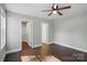 Bright bedroom with hardwood floors, ceiling fan, and adjacent closet at 402 Digh St, Gastonia, NC 28052