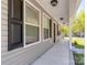 Relaxing front porch with classic columns and neutral-tone siding, offering a shaded outdoor space at 402 Digh St, Gastonia, NC 28052
