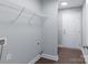 A functional laundry room with storage shelves and neutral gray paint at 402 Digh St, Gastonia, NC 28052