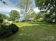 Large, verdant backyard with mature trees, offering a peaceful outdoor setting at 404 S Mulberry St, Cherryville, NC 28021