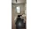 Small bathroom with black flooring, white tiles, a sink, a toilet, and a bath at 404 S Mulberry St, Cherryville, NC 28021