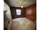 Bedroom featuring hardwood paneled walls, window and ceiling fan at 404 S Mulberry St, Cherryville, NC 28021
