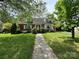 Charming brick home with a well-manicured lawn and a welcoming walkway at 404 S Mulberry St, Cherryville, NC 28021