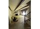 Living room with fireplace, dark exposed beams, large window, and staircase at 404 S Mulberry St, Cherryville, NC 28021