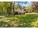 A charming brick exterior with a black garage door, complemented by lush greenery and a bright blue sky at 4110 Charles Raper Jonas Hwy, Alexis, NC 28006