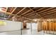 Unfinished basement featuring exposed ceiling beams and a brick fireplace, offering potential for customization at 4110 Charles Raper Jonas Hwy, Alexis, NC 28006