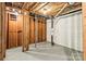 Unfinished basement showcasing exposed pipes and wooden framing, offering potential for future renovations at 4110 Charles Raper Jonas Hwy, Alexis, NC 28006