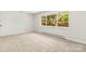 Sunlit bedroom with carpet and large window at 4110 Charles Raper Jonas Hwy, Alexis, NC 28006