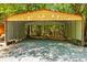 Metal carport with gravel parking area and wooded lot at 4110 Charles Raper Jonas Hwy, Alexis, NC 28006