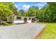 View of the brick home from the driveway surrounded by lush green grass at 4110 Charles Raper Jonas Hwy, Alexis, NC 28006