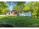 Charming white brick home featuring a covered front porch and lush green lawn at 4110 Charles Raper Jonas Hwy, Alexis, NC 28006