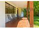 Covered front porch area with stylish black seating perfect for relaxing at 4110 Charles Raper Jonas Hwy, Alexis, NC 28006