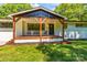 Inviting front porch with wooden beams, seating, and a view of the yard at 4110 Charles Raper Jonas Hwy, Alexis, NC 28006
