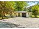 View of a one-story house with an attached garage, gravel driveway and fenced yard at 4110 Charles Raper Jonas Hwy, Alexis, NC 28006