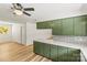 Bright kitchen with white countertop, green cabinets, and stylish backsplash at 4110 Charles Raper Jonas Hwy, Alexis, NC 28006