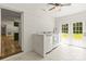 Bright laundry room with white brick and white cabinets with washer, dryer and exterior doors at 4110 Charles Raper Jonas Hwy, Alexis, NC 28006
