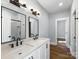Modern bathroom featuring a double sink vanity, large mirrors, and sleek black fixtures and hardware at 424 Fulton Dr, Kings Mountain, NC 28086