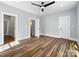 Large bedroom with three entryways, wood floors, light-colored walls, and a modern ceiling fan at 424 Fulton Dr, Kings Mountain, NC 28086