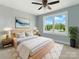 Bright bedroom with a ceiling fan, neutral paint, and a large window overlooking a tree lined street at 424 Fulton Dr, Kings Mountain, NC 28086