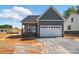 New construction exterior featuring a two-car garage and board and batten details at 424 Fulton Dr, Kings Mountain, NC 28086