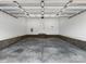 Spacious, empty two-car garage with high ceilings and brick accents at 424 Fulton Dr, Kings Mountain, NC 28086