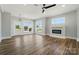 Open-concept living room featuring a fireplace, large windows, and modern ceiling fan at 424 Fulton Dr, Kings Mountain, NC 28086