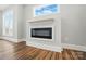 Stylish living room features modern fireplace, light-colored walls, wood floors, and a bright window at 424 Fulton Dr, Kings Mountain, NC 28086