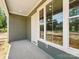 Comfortable front porch featuring green siding and bright white trim at 424 Fulton Dr, Kings Mountain, NC 28086