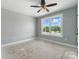 Empty room with an overhead ceiling fan, a window and visible flooring sub-straight ready for new finishes at 424 Fulton Dr, Kings Mountain, NC 28086