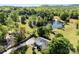 A scenic aerial view of a single Gathering home with a pond surrounded by lush greenery and trees at 459 Cramerton Rd, Gastonia, NC 28056