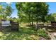 Lush backyard with a wooden fence overlooking a serene pond and grazing sheep at 459 Cramerton Rd, Gastonia, NC 28056
