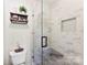 Stylish shower with a glass door, built-in seat, and decorative tile accents at 459 Cramerton Rd, Gastonia, NC 28056