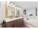 Elegant bathroom featuring a double vanity with wood cabinets and a soaking tub at 459 Cramerton Rd, Gastonia, NC 28056