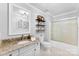 Well-lit bathroom features granite countertops, updated fixtures, and shower-tub combo at 459 Cramerton Rd, Gastonia, NC 28056