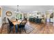Dining area with a chandelier, hardwood flooring, view into the kitchen, and a wooden dining table at 459 Cramerton Rd, Gastonia, NC 28056