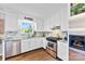 Bright kitchen features white cabinets, granite countertops, stainless appliances and natural light at 459 Cramerton Rd, Gastonia, NC 28056