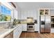 Updated kitchen featuring white cabinets, granite countertops, and stainless steel appliances at 459 Cramerton Rd, Gastonia, NC 28056