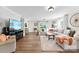 Inviting living room with hardwood floors, neutral walls, and a large sectional sofa, perfect for gatherings at 459 Cramerton Rd, Gastonia, NC 28056